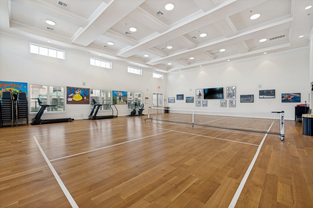 The resort-style fitness center at The Victoria includes pickleball courts supporting active senior living in McKinney TX.