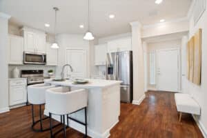 Modern kitchens feature high-end appliances in upscale senior living apartments.